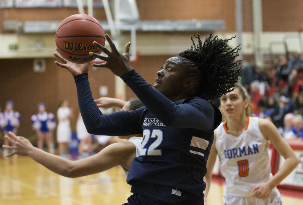 Centennial senior Eboni Walker (22) drives baseline past Bishop Gorman sophomore Izzy Westbr ...