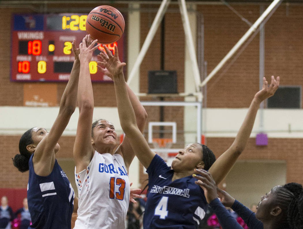 Bishop Gorman senior Georgia Ohiaeri (13) fights for a rebound with Centennial sophomore Tay ...