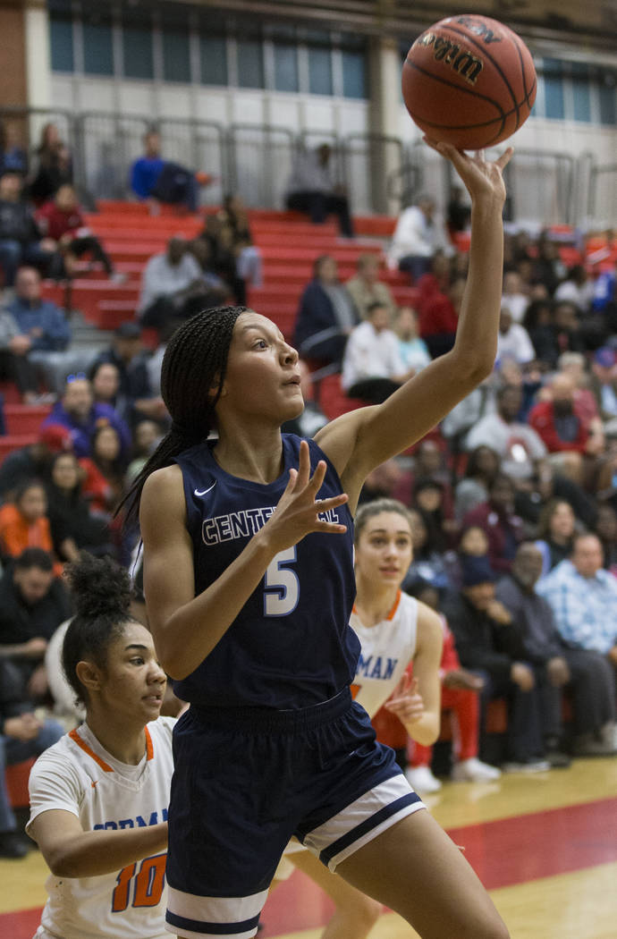 Centennial junior Jade Thomas (5) shoots a baseline runner past Bishop Gorman senior Maleah ...