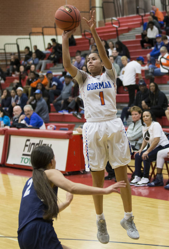 Bishop Gorman senior Caira Young (1) shoots a corner three over Centennial senior Melanie Is ...