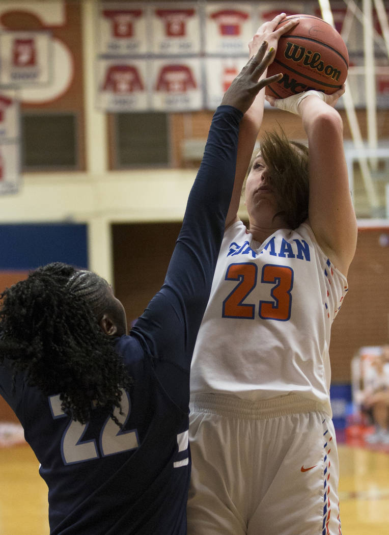 Bishop Gorman senior Tierney Holcombe (23) shoots over Centennial senior Eboni Walker (22) i ...