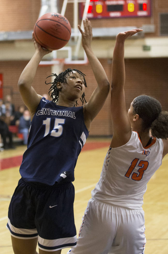 Centennial junior Daejah Phillips (15) shoots over Bishop Gorman senior Georgia Ohiaeri (13) ...