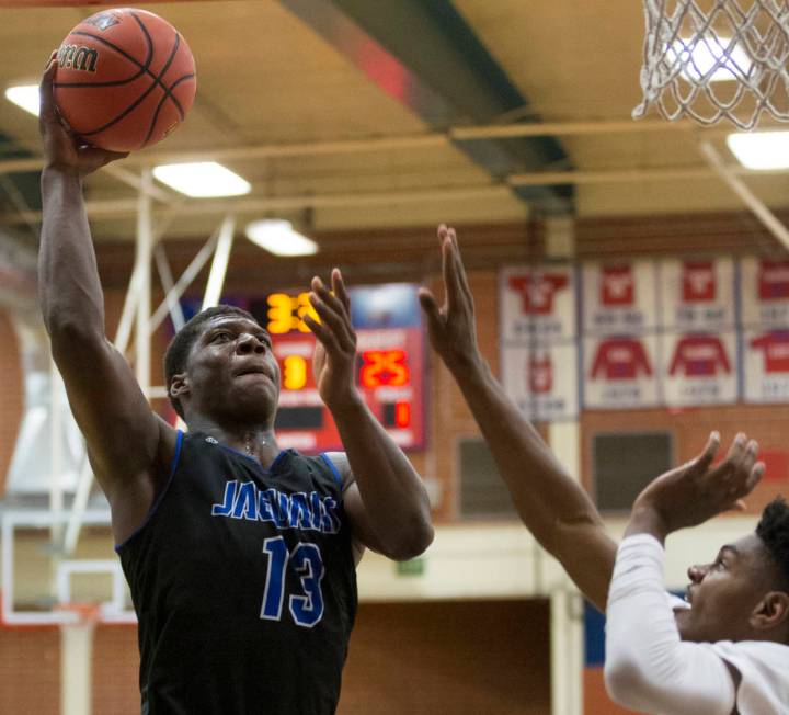 Desert Pines junior Darnell Washington (13) drives to the rim over Bishop Gorman sophomore g ...