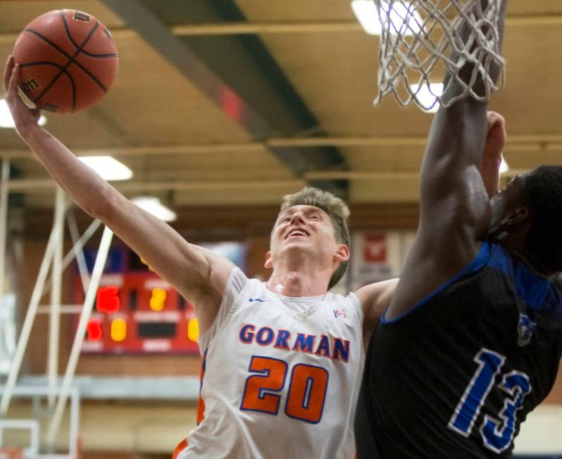 Bishop Gorman senior guard Noah Taitz (20) slices to the rim over Desert Pines junior Darnel ...