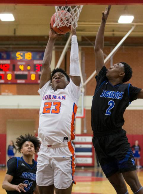 Bishop Gorman junior forward Mwani Wilkinson (23) drives past Desert Pines sophomore Dayshaw ...