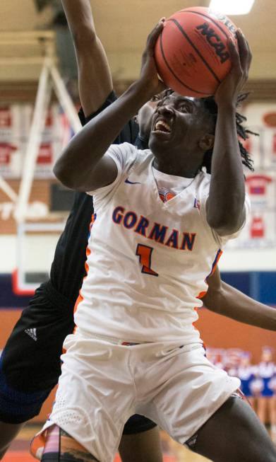 Bishop Gorman sophomore guard Will McClendon (1) drives baseline past Desert Pines sophomore ...