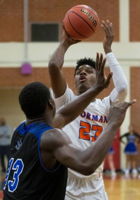 Bishop Gorman junior forward Mwani Wilkinson (23) shoots a jump shot over Desert Pines junio ...