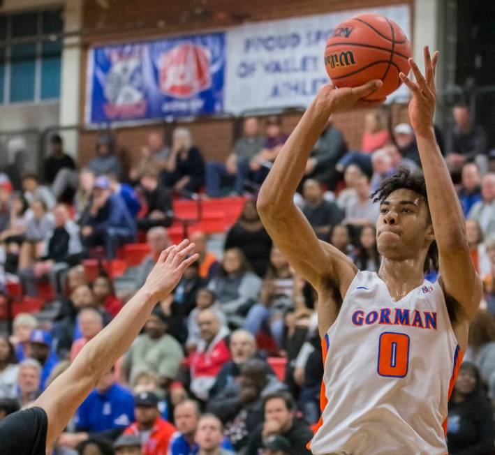 Bishop Gorman junior forward Isaiah Cottrell (0) shoots a corner three over a Desert Pines d ...