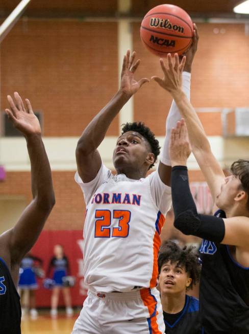 Bishop Gorman junior forward Mwani Wilkinson (23) shoots over Desert Pines sophomore Cimarro ...