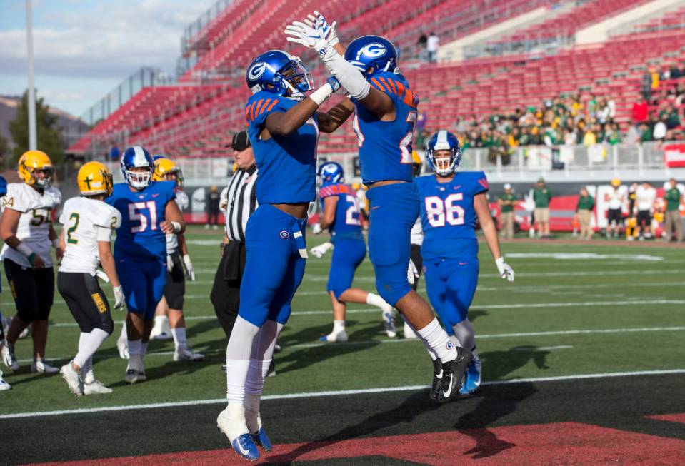 Bishop Gorman running back Amod Cianelli (23), right, celebrates his touchdown with Donovan ...