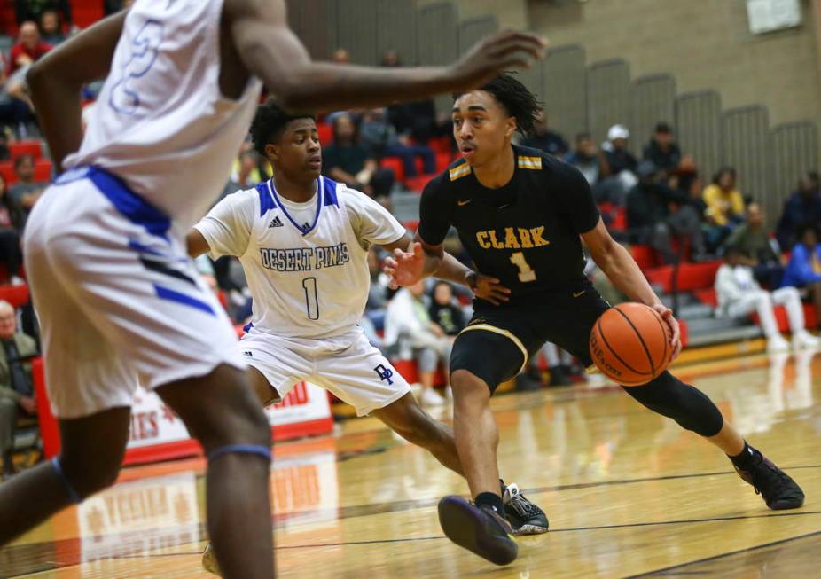 Clark’s Frankie Collins (1) drives against Desert Pines’ Semaj Threats (1) durin ...