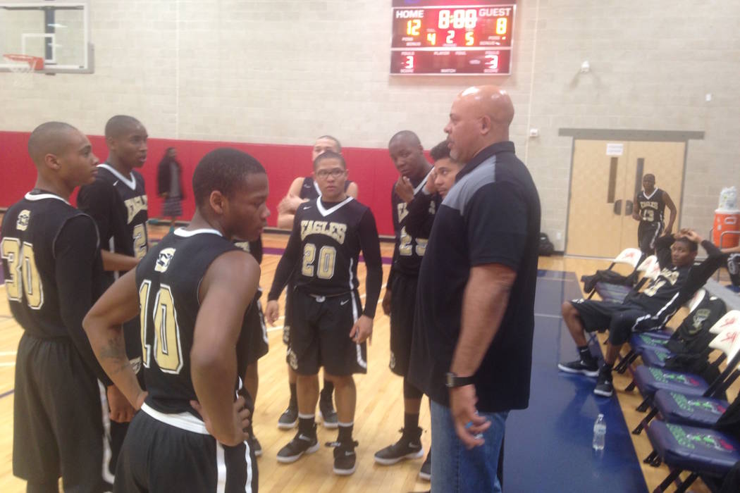 Spring Mountain coach Asad Ali talks to his team after the first quarter of the Golden Eagle ...