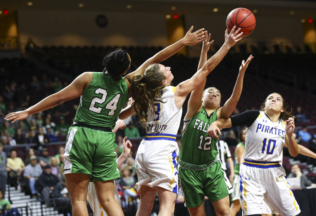 Churchill County’s Leta Otuafi (24) and Alexis Jarrett (12) battle for a rebound again ...