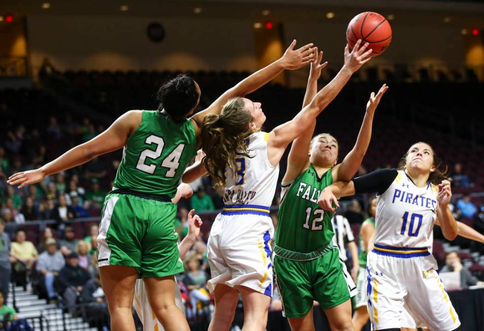 Churchill County’s Leta Otuafi (24) and Alexis Jarrett (12) battle for a rebound again ...