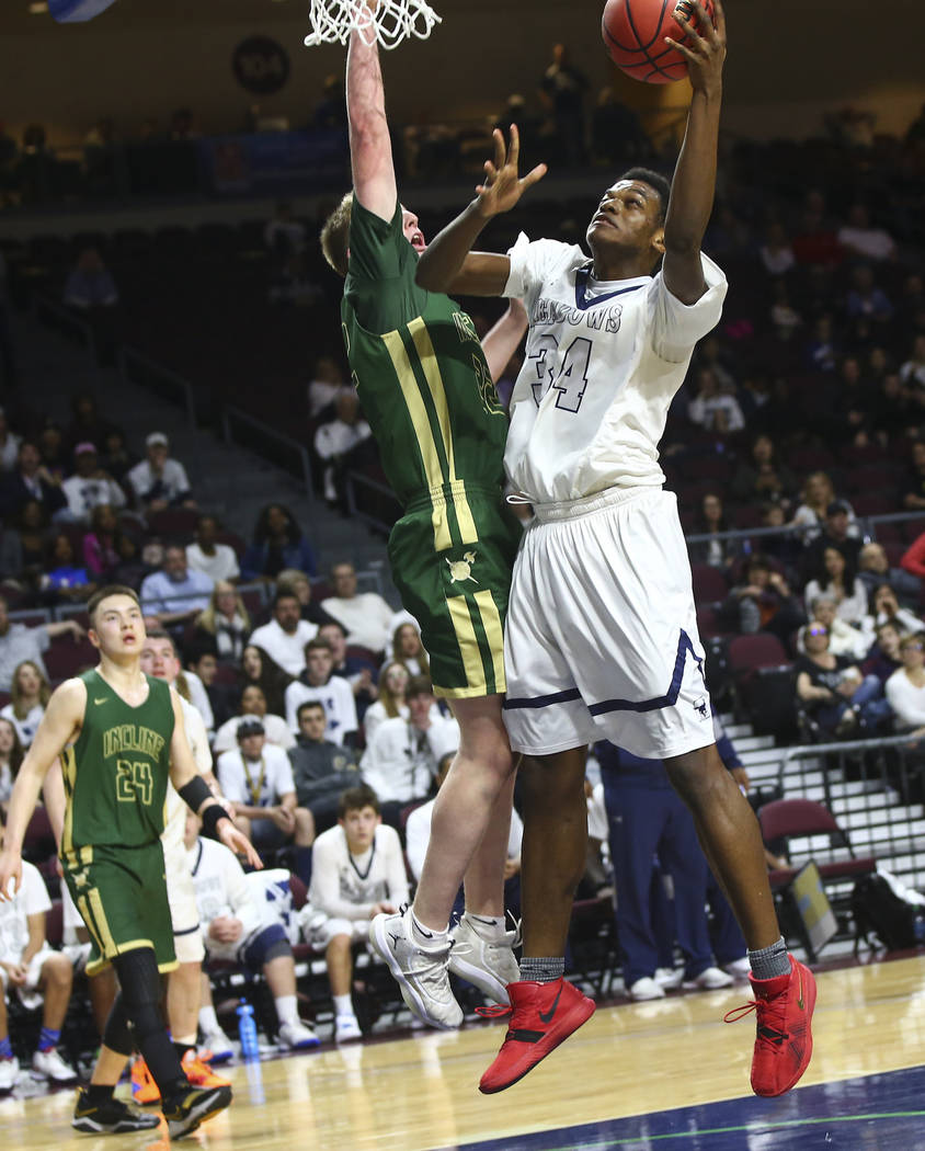 The Meadows’ Obinna Ezeanolue (34) goes to the basket against Incline guard Liam Nolan ...