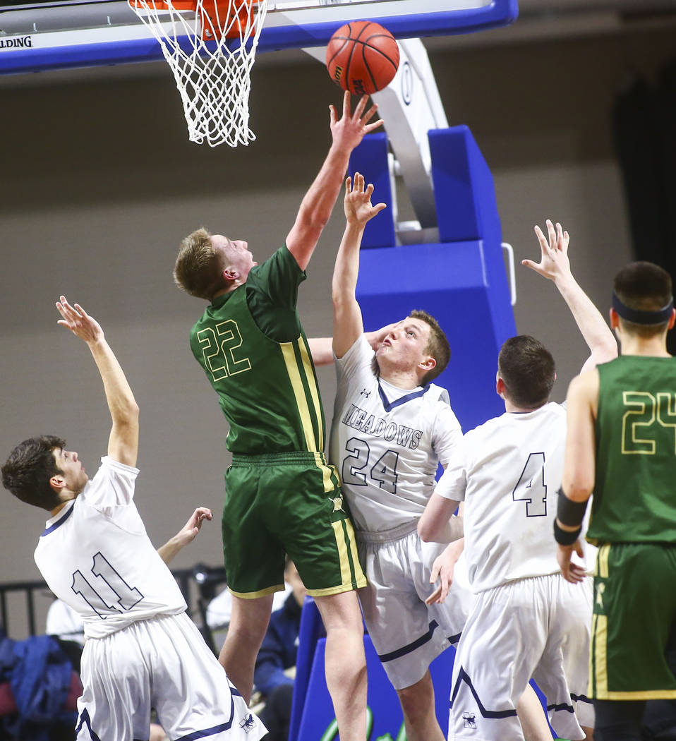 Incline guard Liam Nolan-Bowers (22) shoots over The Meadows guard Allen Fridman (24) during ...