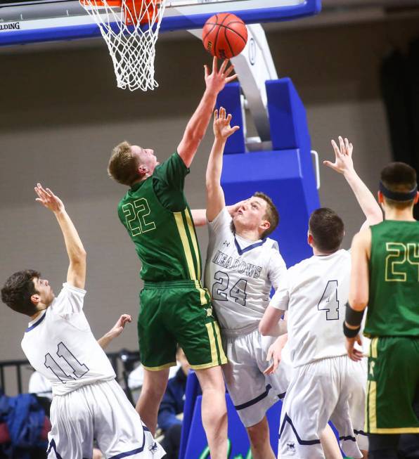 Incline guard Liam Nolan-Bowers (22) shoots over The Meadows guard Allen Fridman (24) during ...