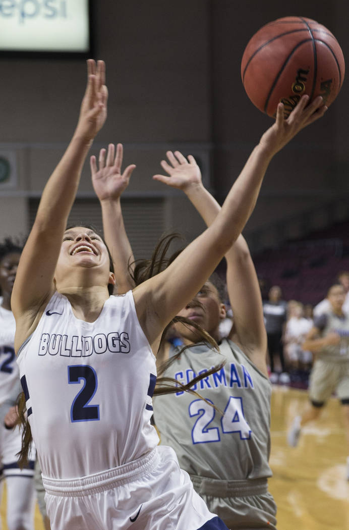 Centennial senior Melanie Isbell (2) drives past Bishop Gorman junior Bentleigh Hoskins (24) ...