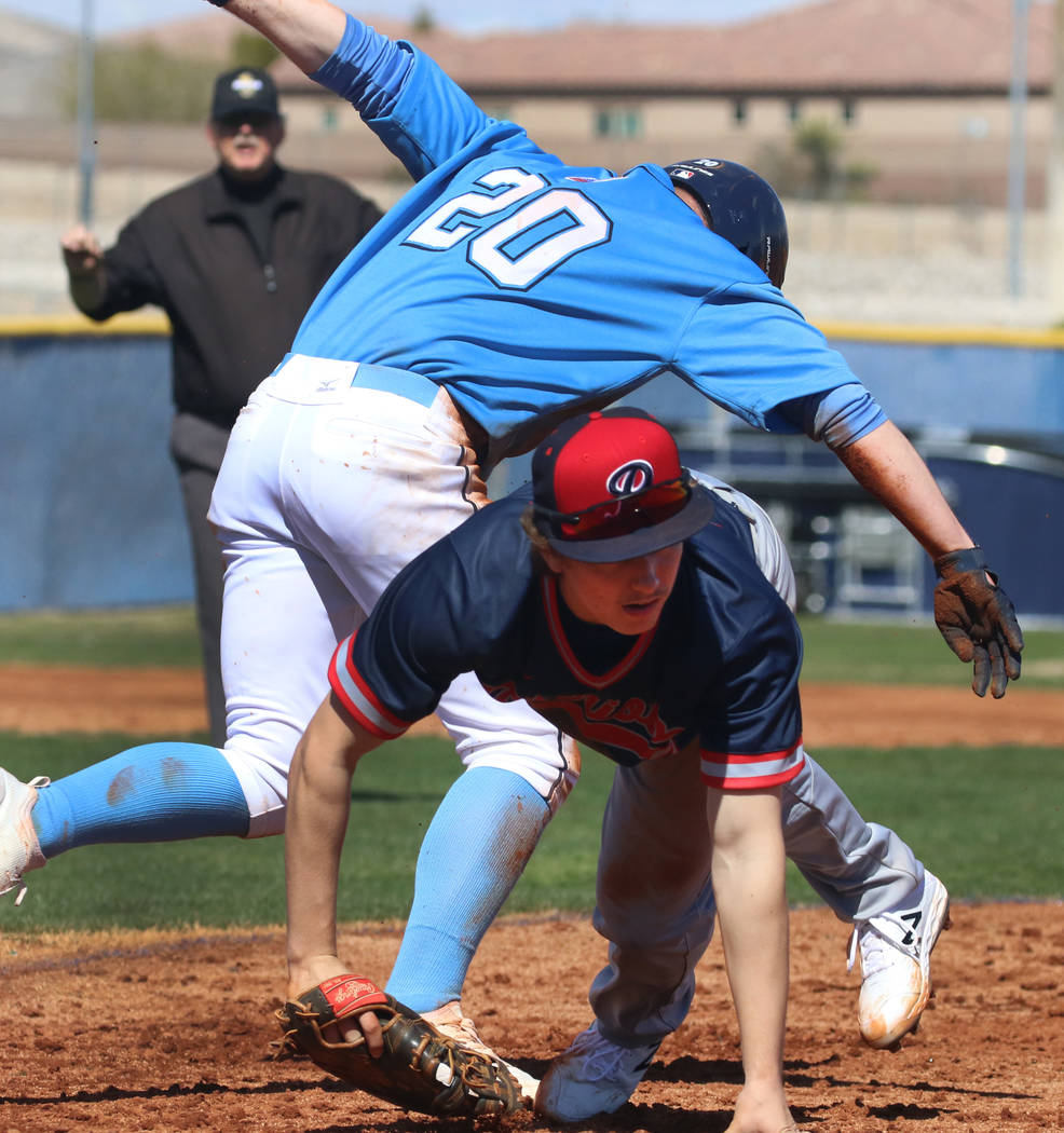 Centennial’s Travis Rice (20) and Liberty’s Ethan Safier collide at second durin ...