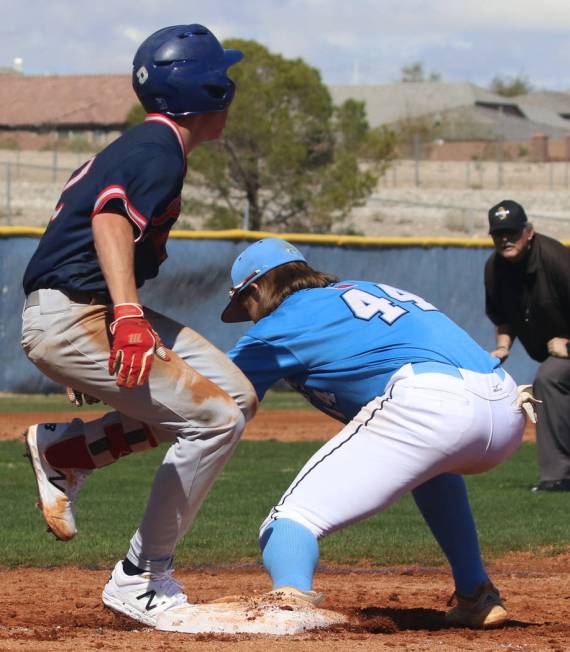 Centennial’s third baseman Kris Bow (44) tags Liberty’s Jack Hale during their b ...