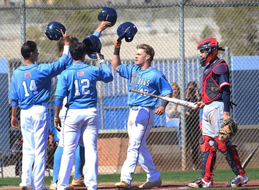 Centennial’s Austin Kryszczuk (47) celebrates with his teammates after hitting a 3-run ...