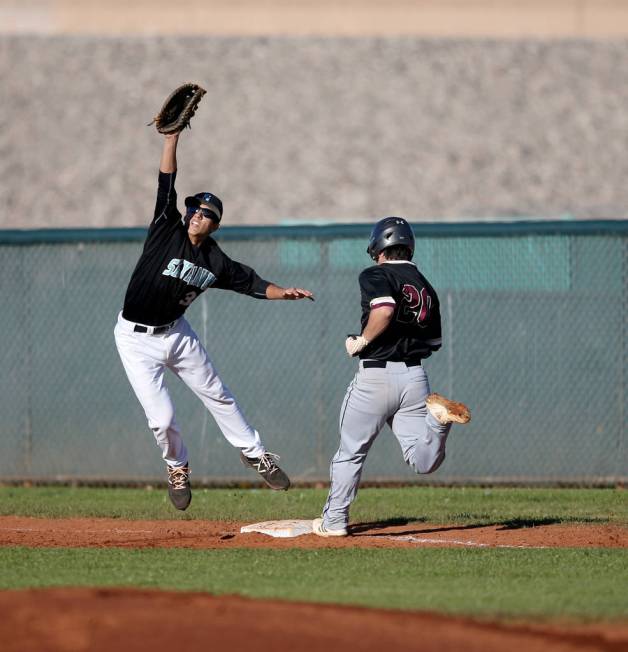 Faith Lutheran Dylan Howell (20) crosses first base as Silverado first baseman Jarod Hill (3 ...
