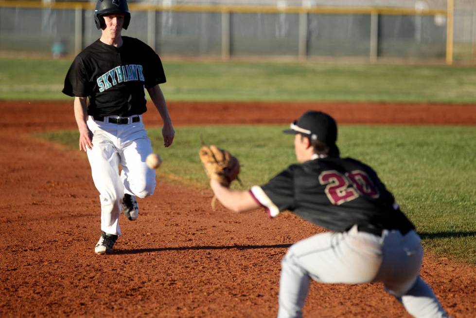 Faith Lutheran third baseman Dylan Howell (20) prepares to tag out Silverado baserunner Andr ...