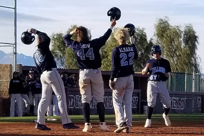 Centennial players Sam Simon (16), Kris Bow (42) and Rene Almarez (22) greet teammate Austin ...