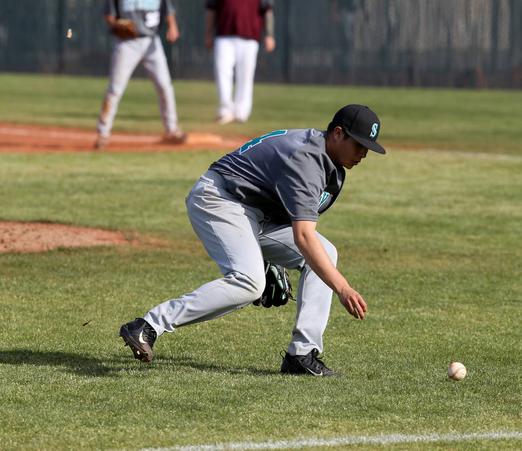 Silverado pitcher Angel Garcia (4) looks to grab a bunt against Cimarron-Memorial in the thi ...