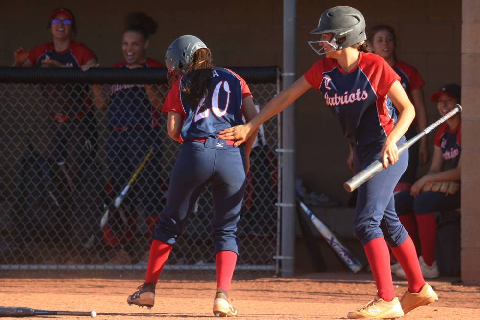 Liberty’s Jessica Meza (20), left, celebrates her run with Shelby Carvalho (13) in the ...