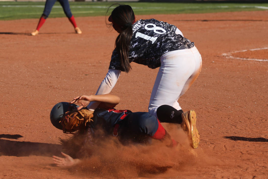 Desert Oasis’ Jaid Riana Raval (18) tags out Liberty’s Rebecca Warren (1) at thi ...