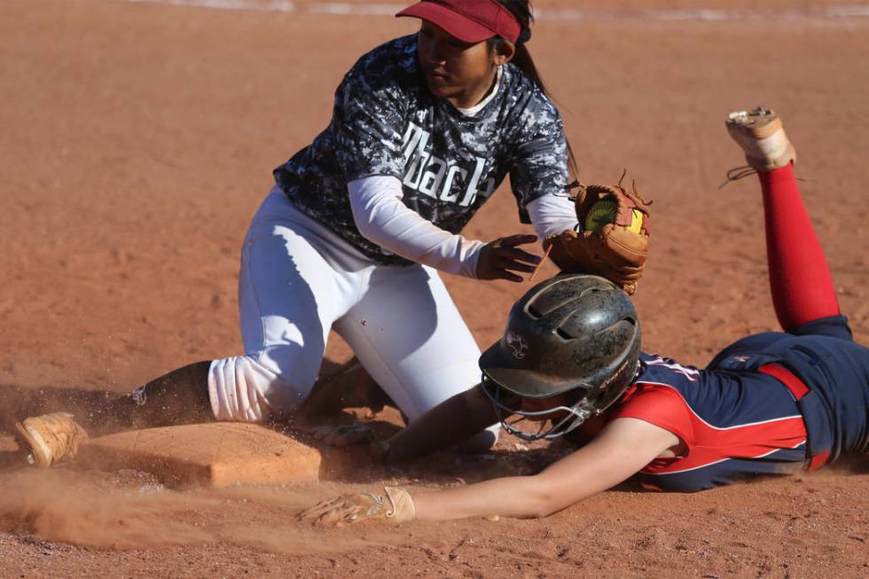 Liberty’s McKenzie LaNeve (42) slides safely back to third base against Desert Oasis&# ...