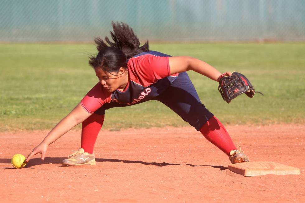 Liberty’s Debra Tofi (44) fails to make a play to allow a base hit against Desert Oasi ...