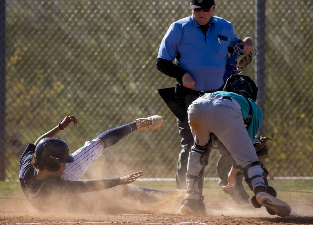 Coronado’s Thomas Planellas (25) slides but is tagged out at home base by Silverado ca ...