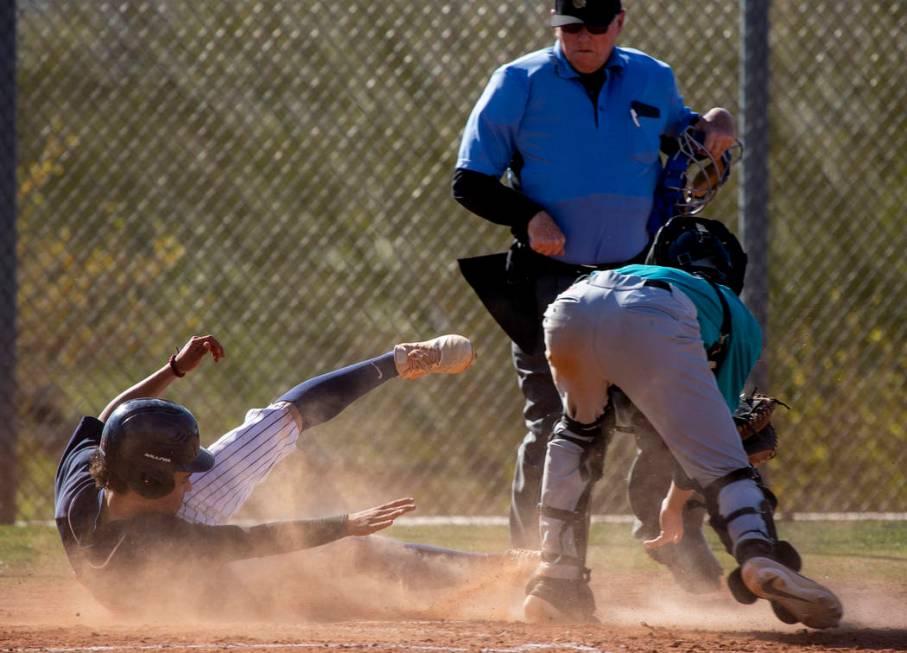 Coronado’s Thomas Planellas (25) slides but is tagged out at home base by Silverado ca ...