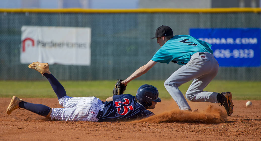 Coronado’s Thomas Planellas (25) dives safely back to first base after errant throw to ...