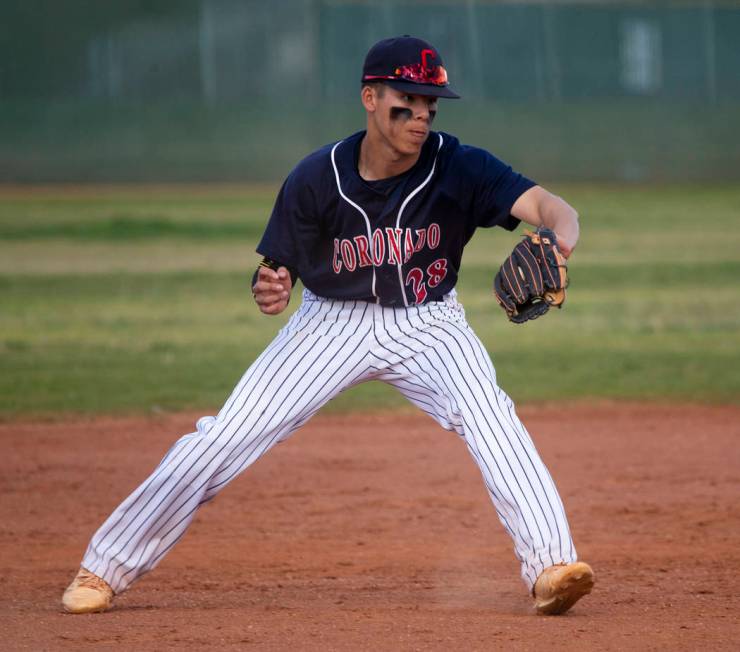 Coronado infielder Josh Johnson (28) grabs a tough hop from a Silverado batter during their ...