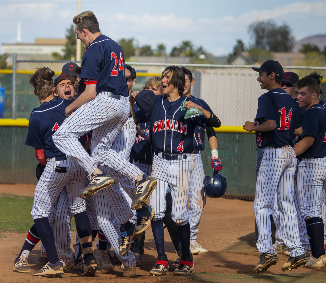 Coronado players celebrate a two-run home run while dominating Silverado during their baseba ...