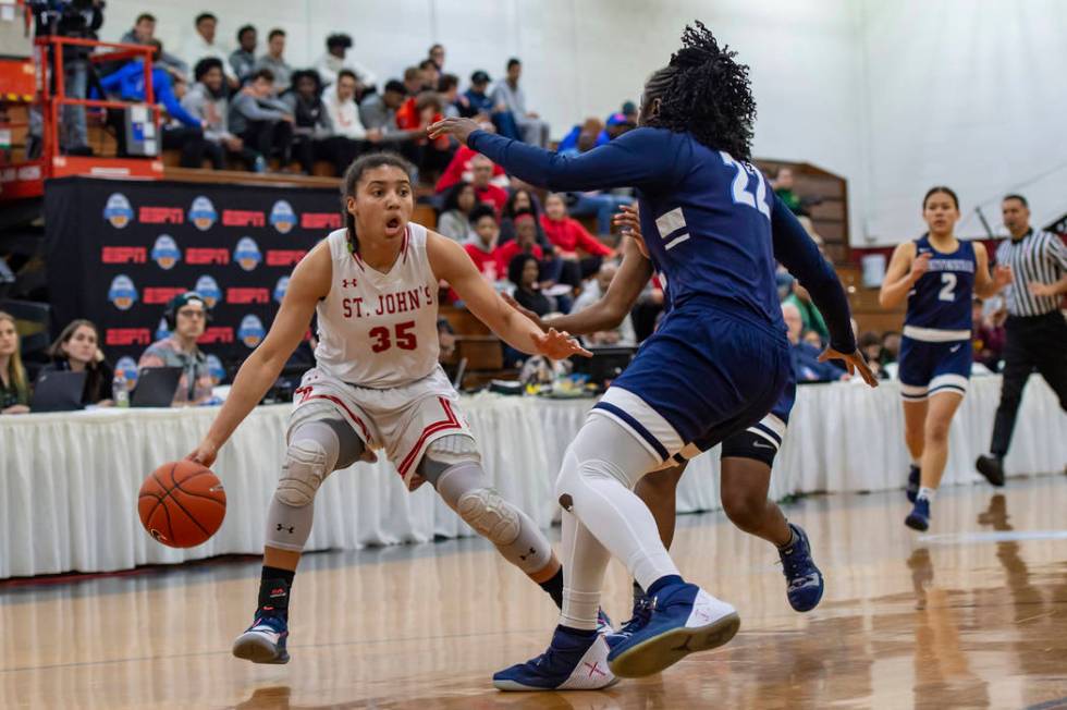 Centennial’s Eboni Walker (22) defends St. John’s sophomore Azzi Fudd (35) durin ...