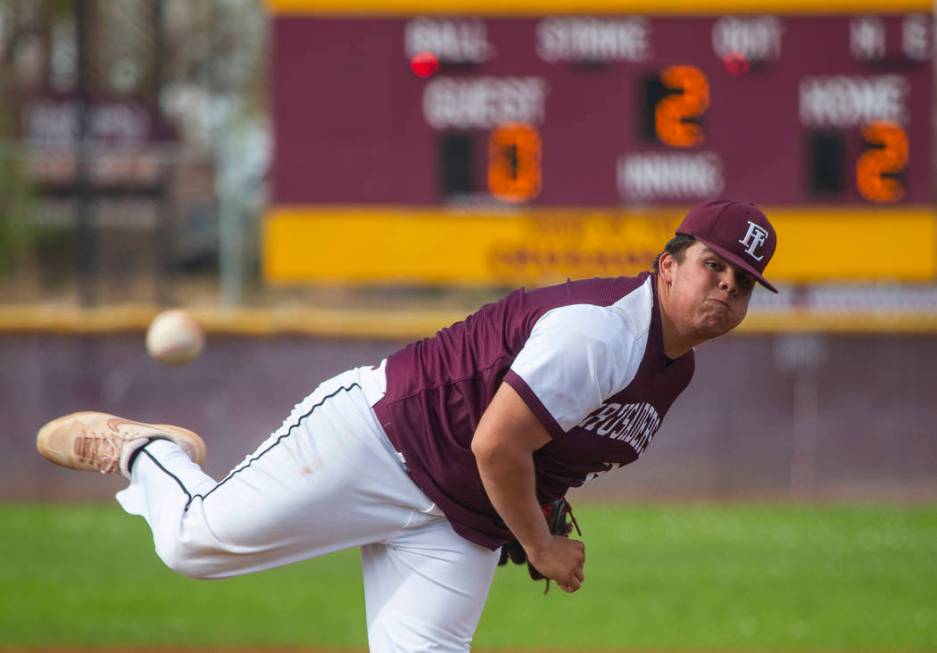 Faith Lutheran’s pitcher Christian Dijkman (21) sends another ball towards the plate v ...