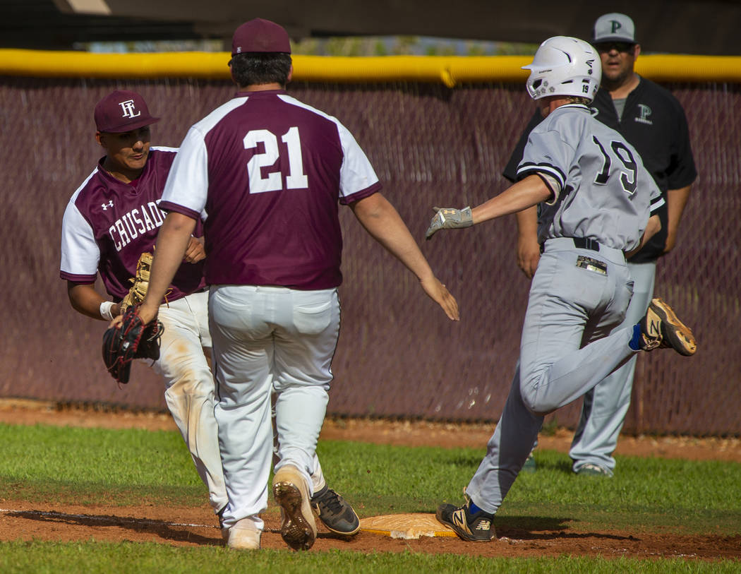 Faith Lutheran’s Jacob Ortega (8) gets back to first base for the out before Palo Verd ...