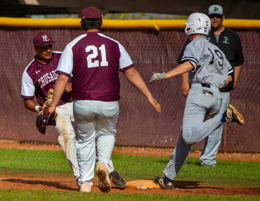 Faith Lutheran’s Jacob Ortega (8) gets back to first base for the out before Palo Verd ...