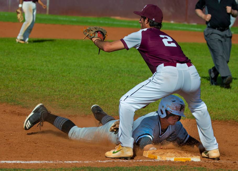 Palo Verde’s Paul Myro IV (23) dives to tag third base ahead of a throw to Faith Luthe ...