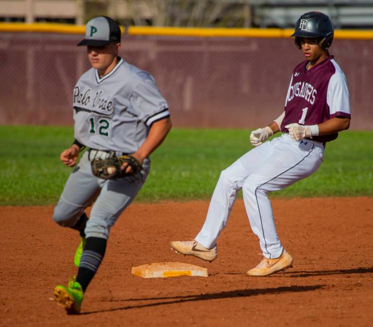 Palo Verde’s (12) has to step off the bag for a wild throw as Faith Lutheran’s D ...