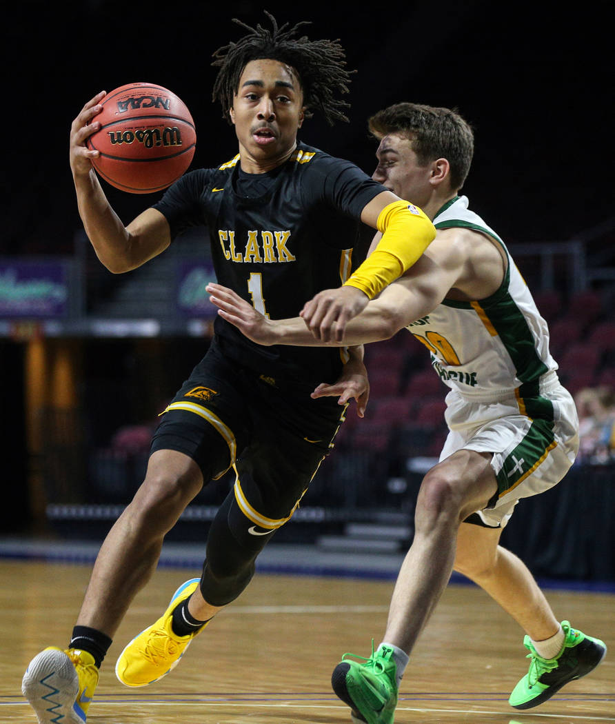 Clark’s Frankie Collins (1) runs with the ball while being guarded by Bishop Manogue&# ...