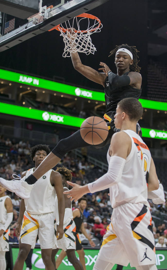 C.J. Walker (14) dunks over Samuell Williamson (10) in the first half during the Jordan Bran ...