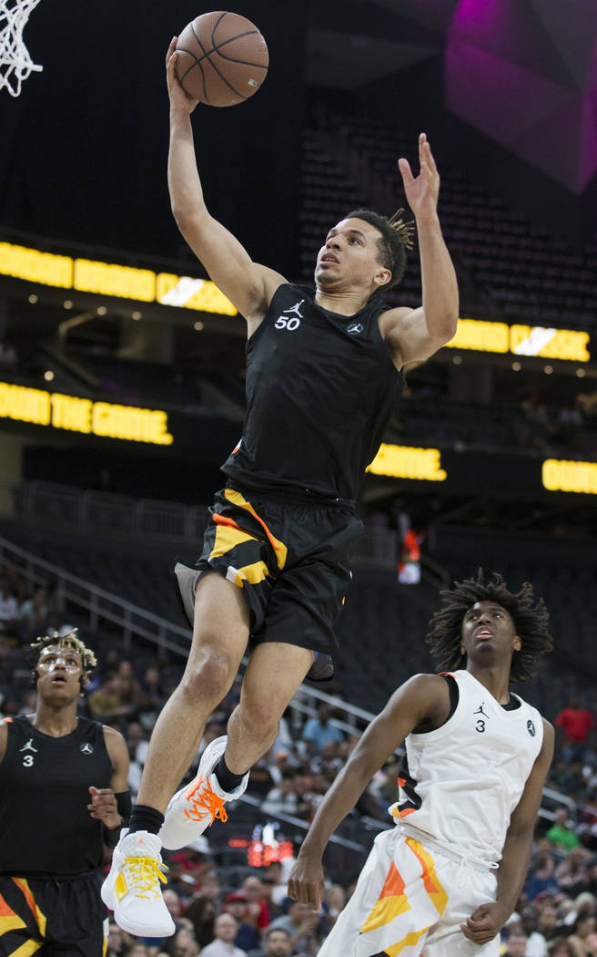 Cole Anthony (50) slices to the rim past Tyrese Maxey (3) in the first half during the Jorda ...