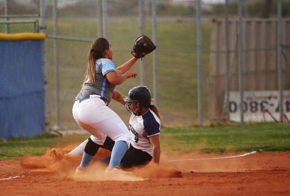 Centennial High School’s Sofia Ruelas (10) fails to tag out Shadow Ridge High School&# ...