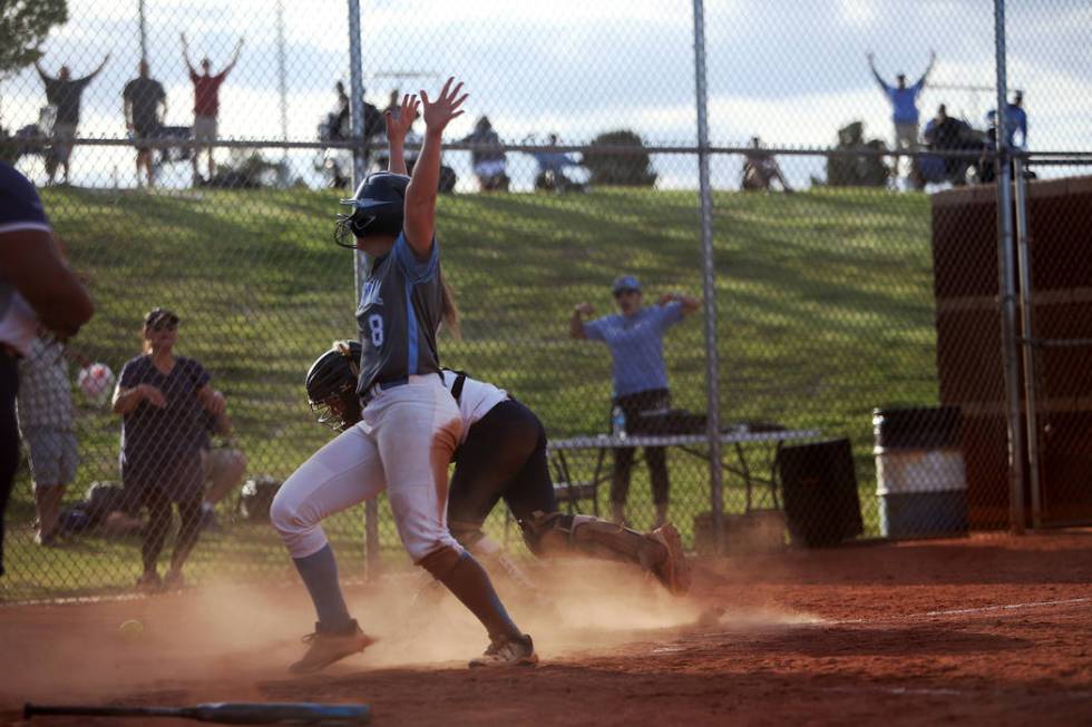 Centennial High School’s Ashlynn Heck (8) scores the winning run against Shadow Ridge ...