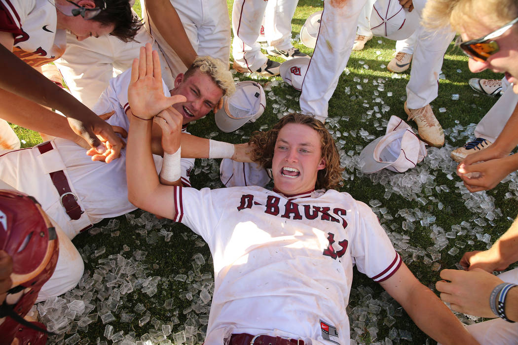 Desert Oasis’ pitcher Josh Sharman (11) celebrates a win with his team over Basic in t ...